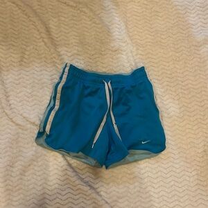 Blue Nike shorts with adjustable graw strings worn